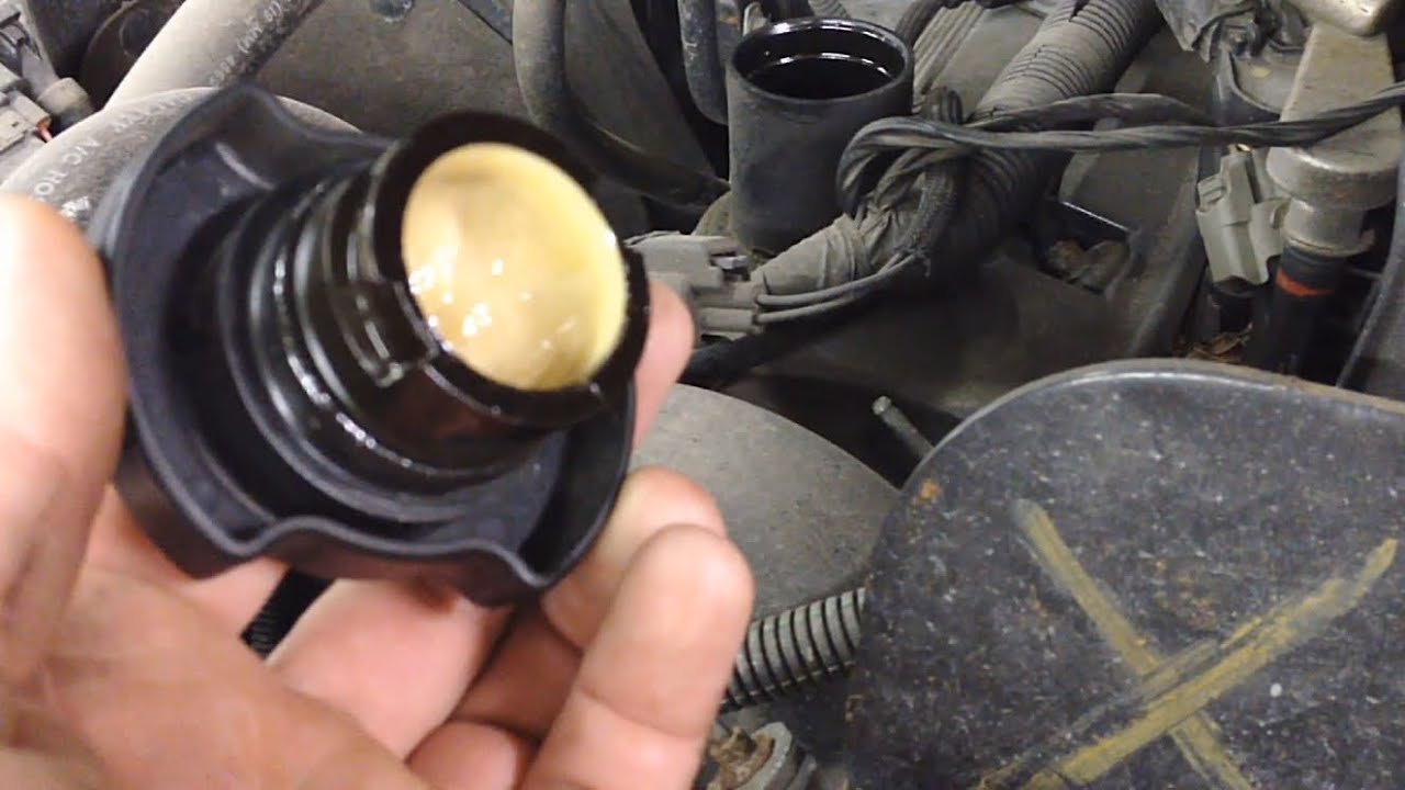 With the engine off, check under the oil cap